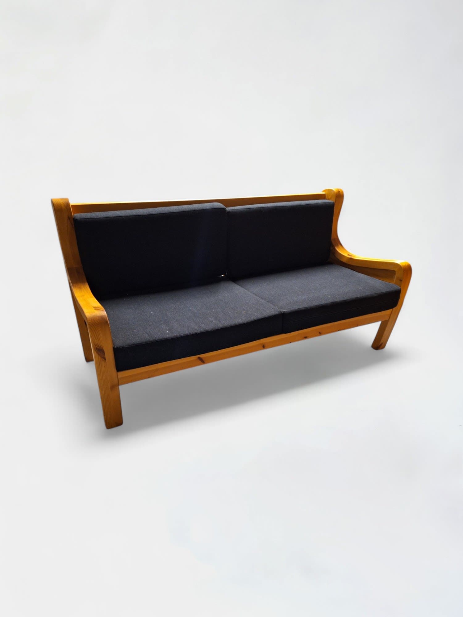 Tan wooden bench with black cushions-0