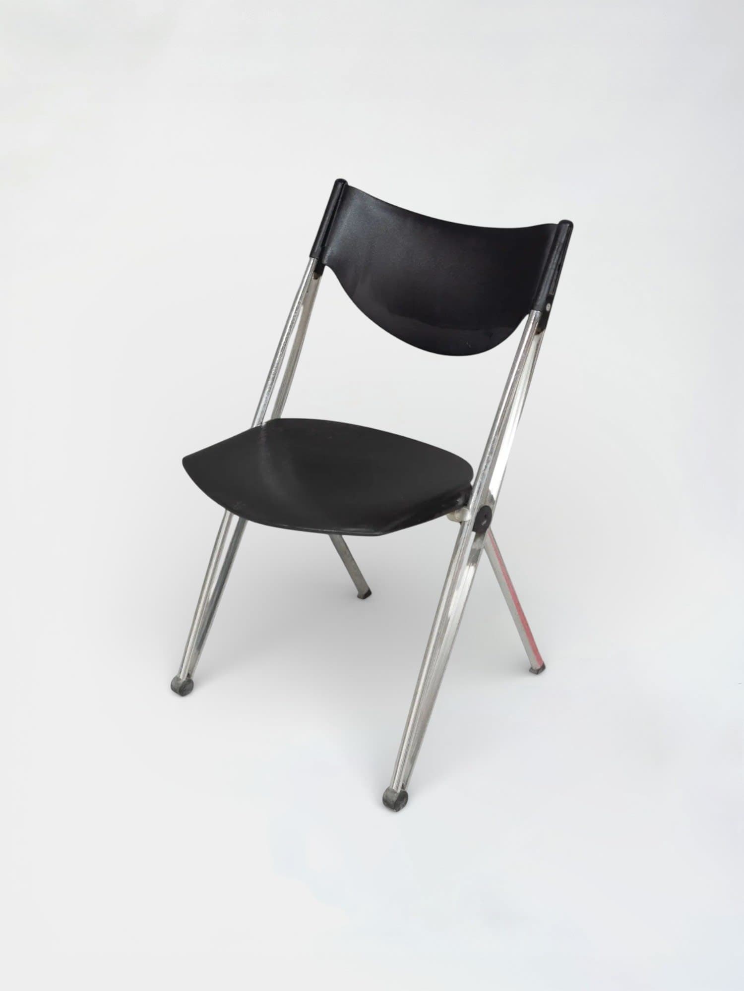 Black plastic folding chair with chrome legs and ergonomic design-4