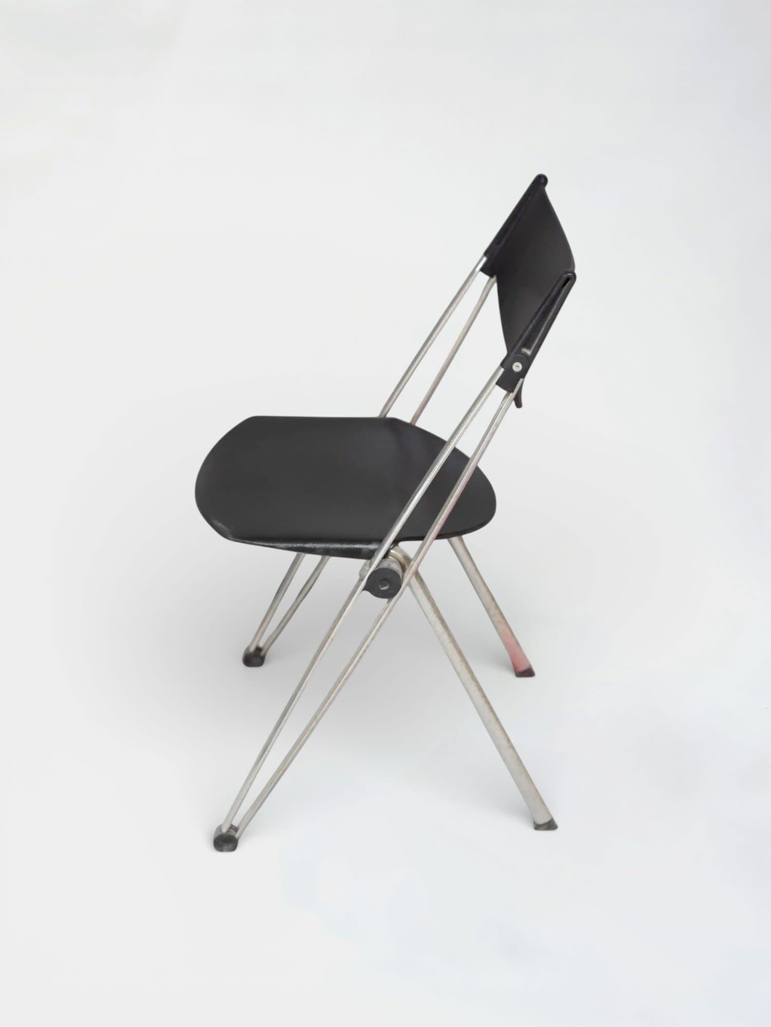 Black plastic folding chair with chrome legs and ergonomic design-3