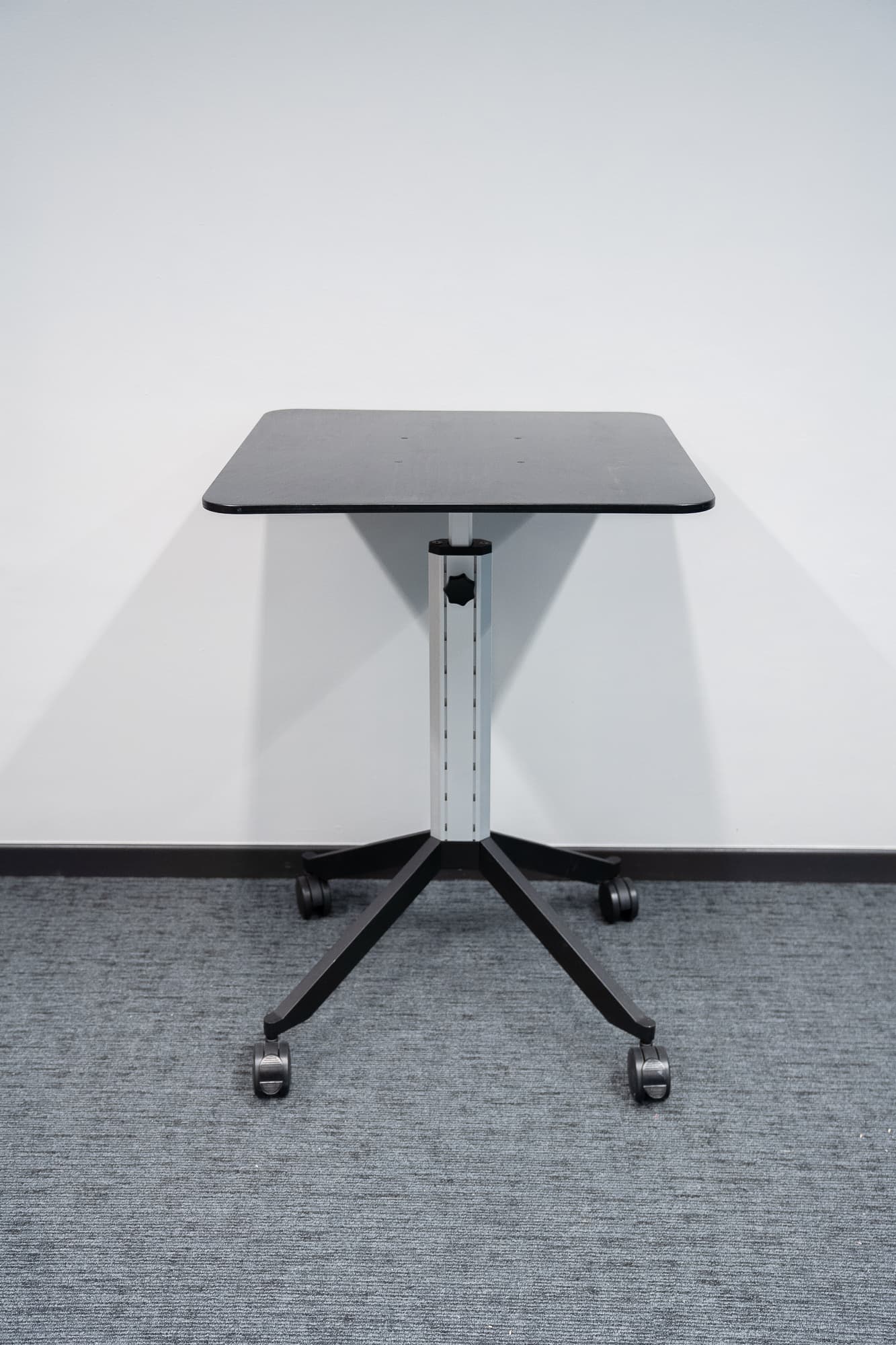 Black mobile table with height-adjustable on wheels-0