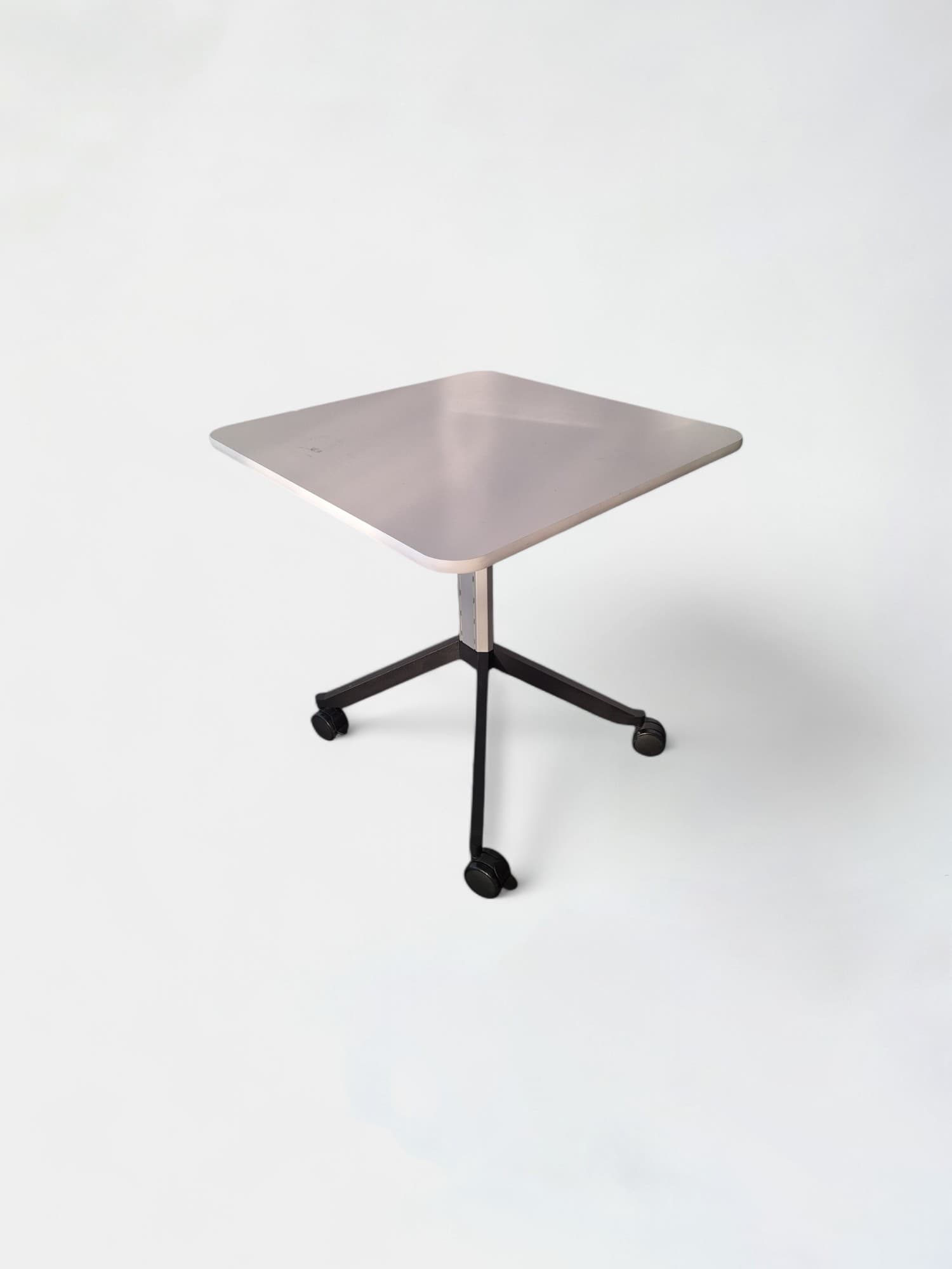 White square table with black legs and adjustable height