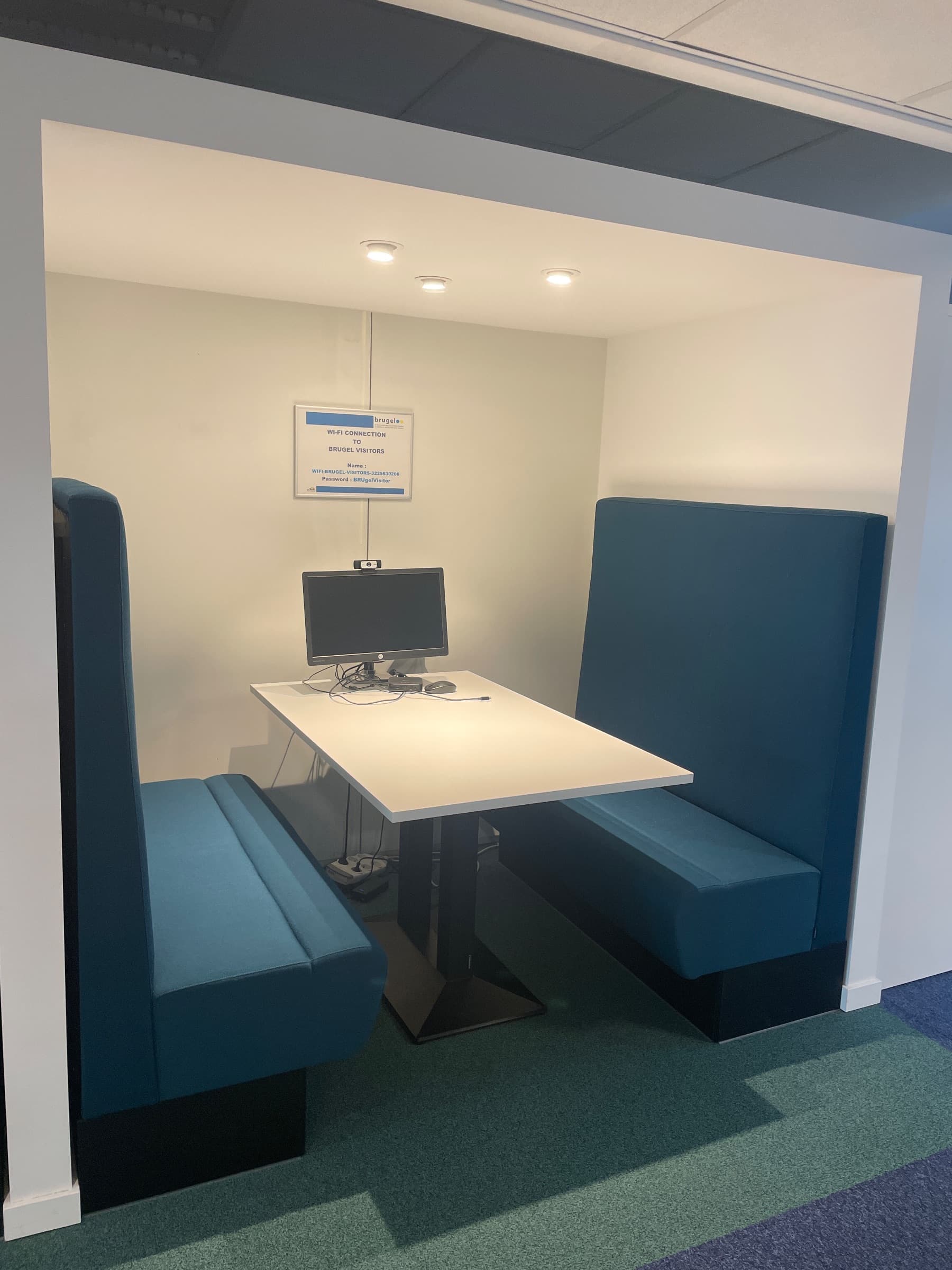 Teal stoffen vergadercabine met witte tafel en geïntegreerde technologie-0