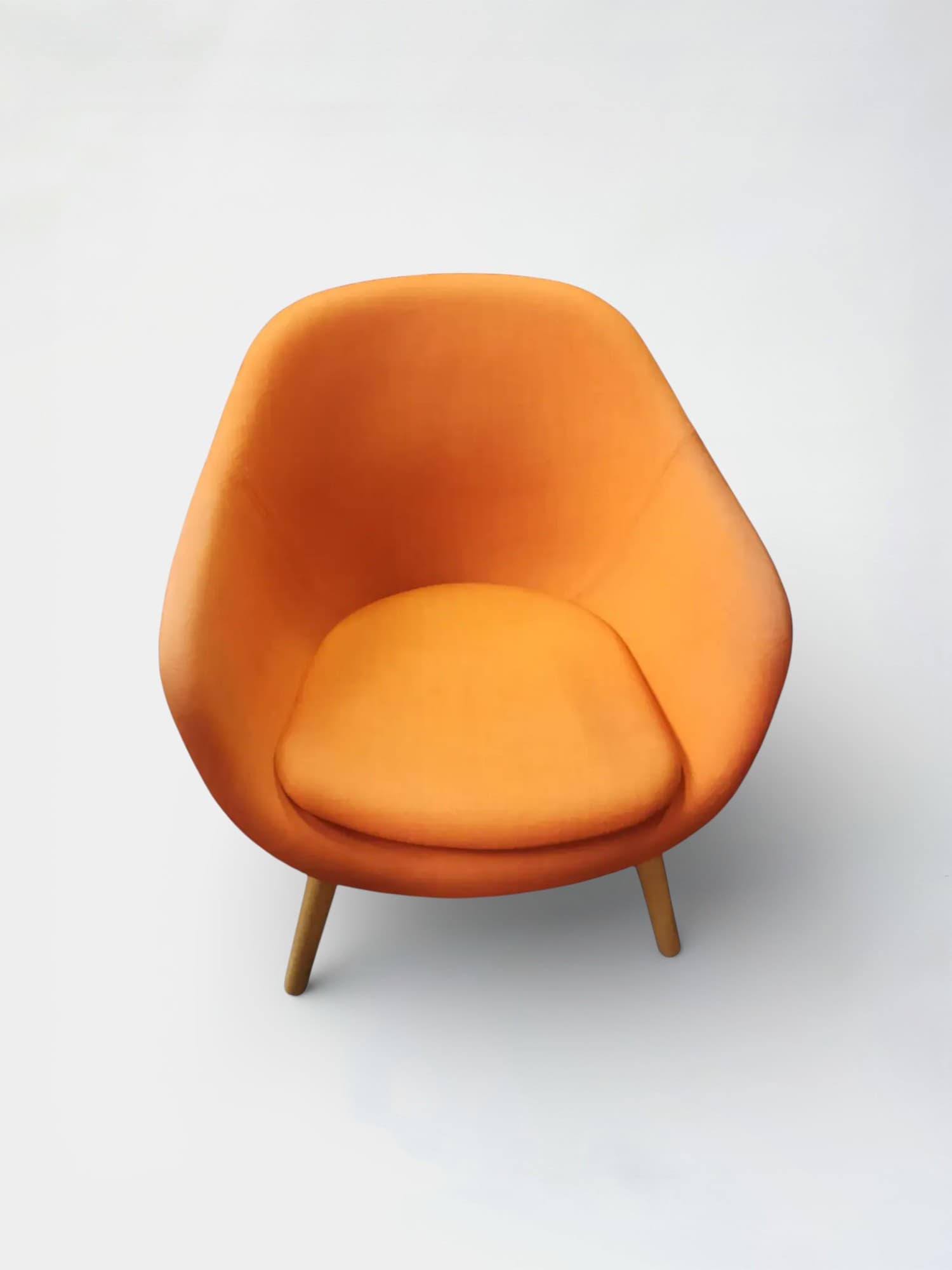 Orange armchair on wooden legs. Signs on use on the armrests-0