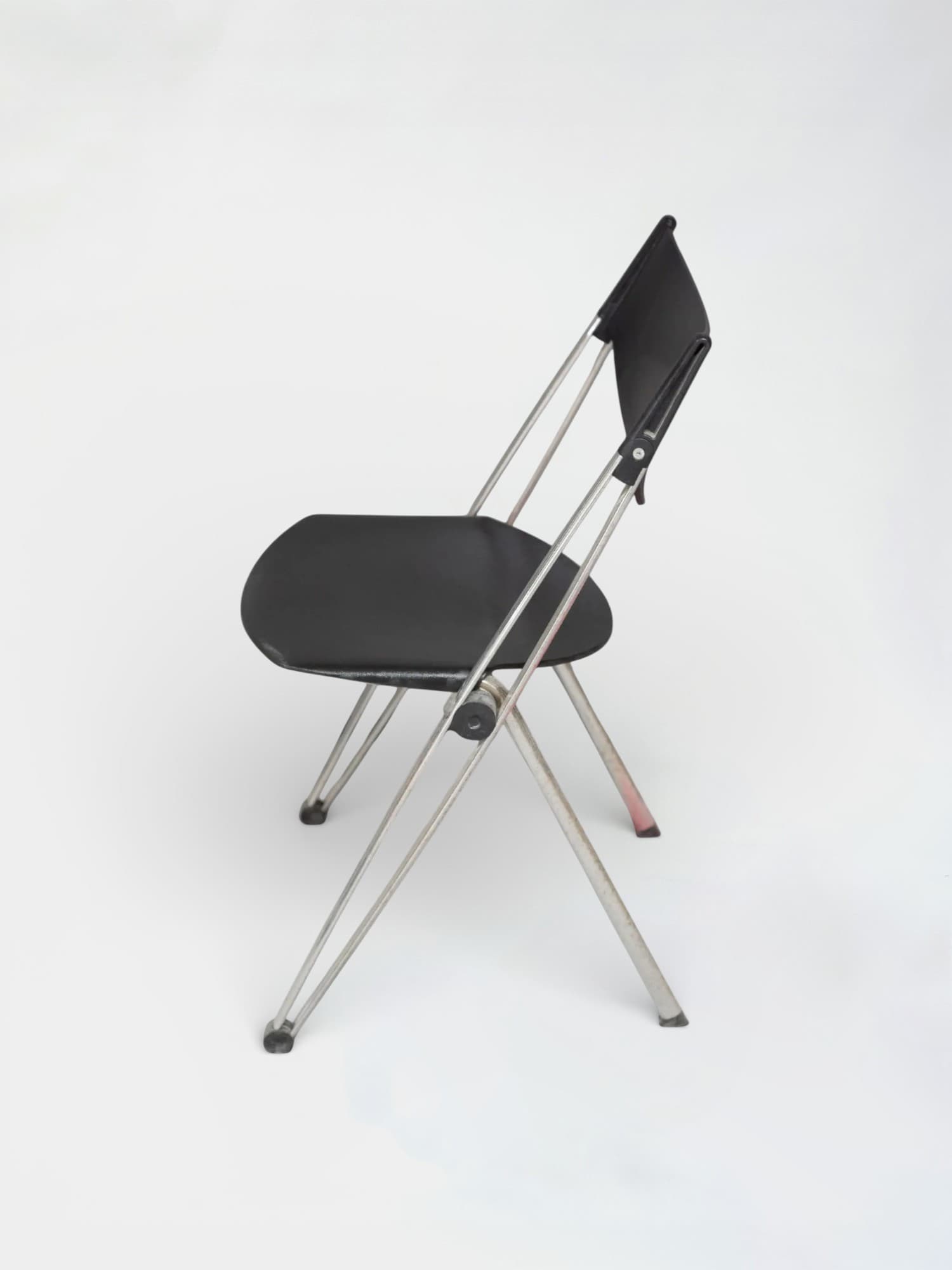 Black plastic folding chair with chrome legs and ergonomic design-4