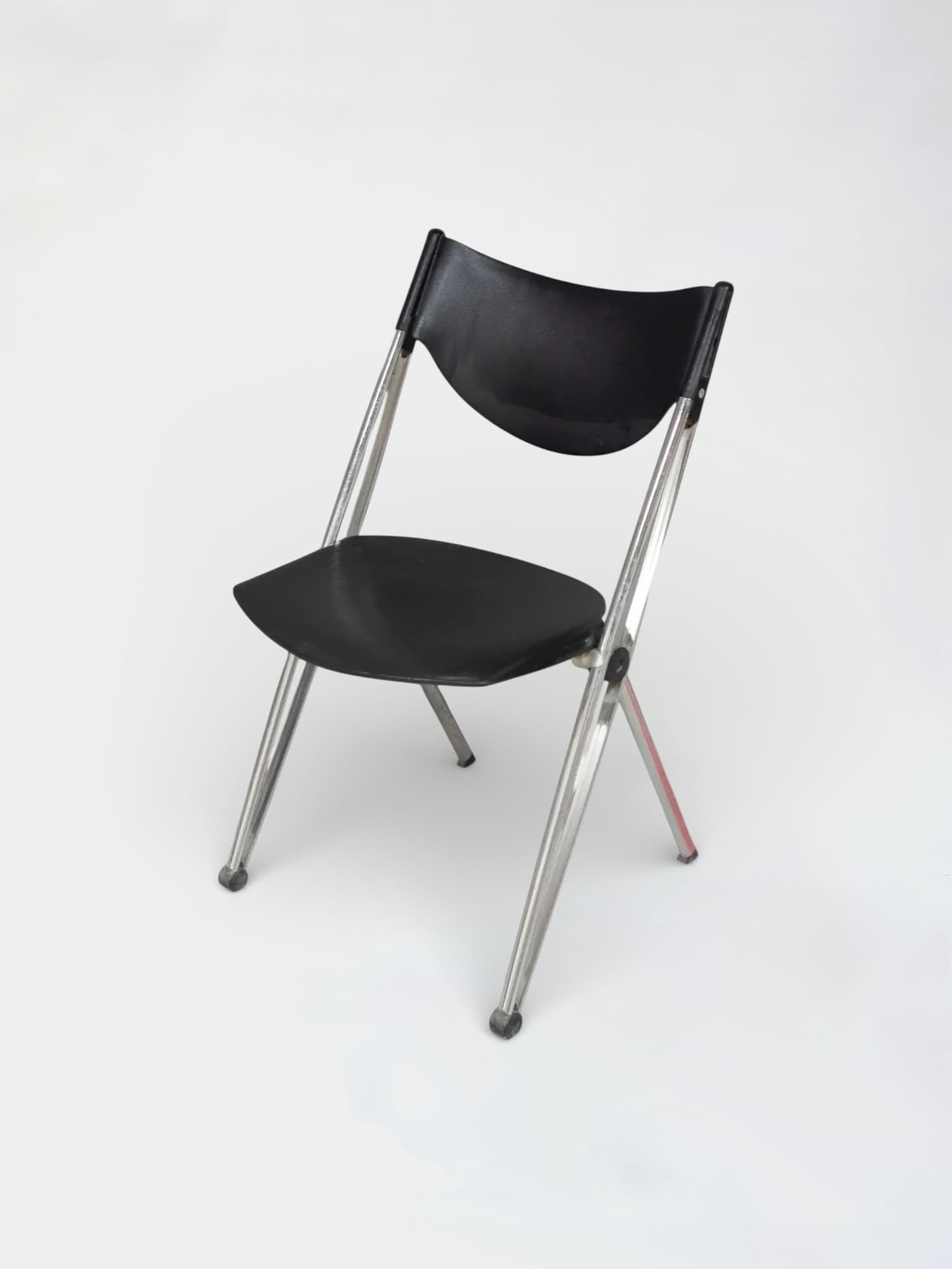Black plastic folding chair with chrome legs and ergonomic design-0