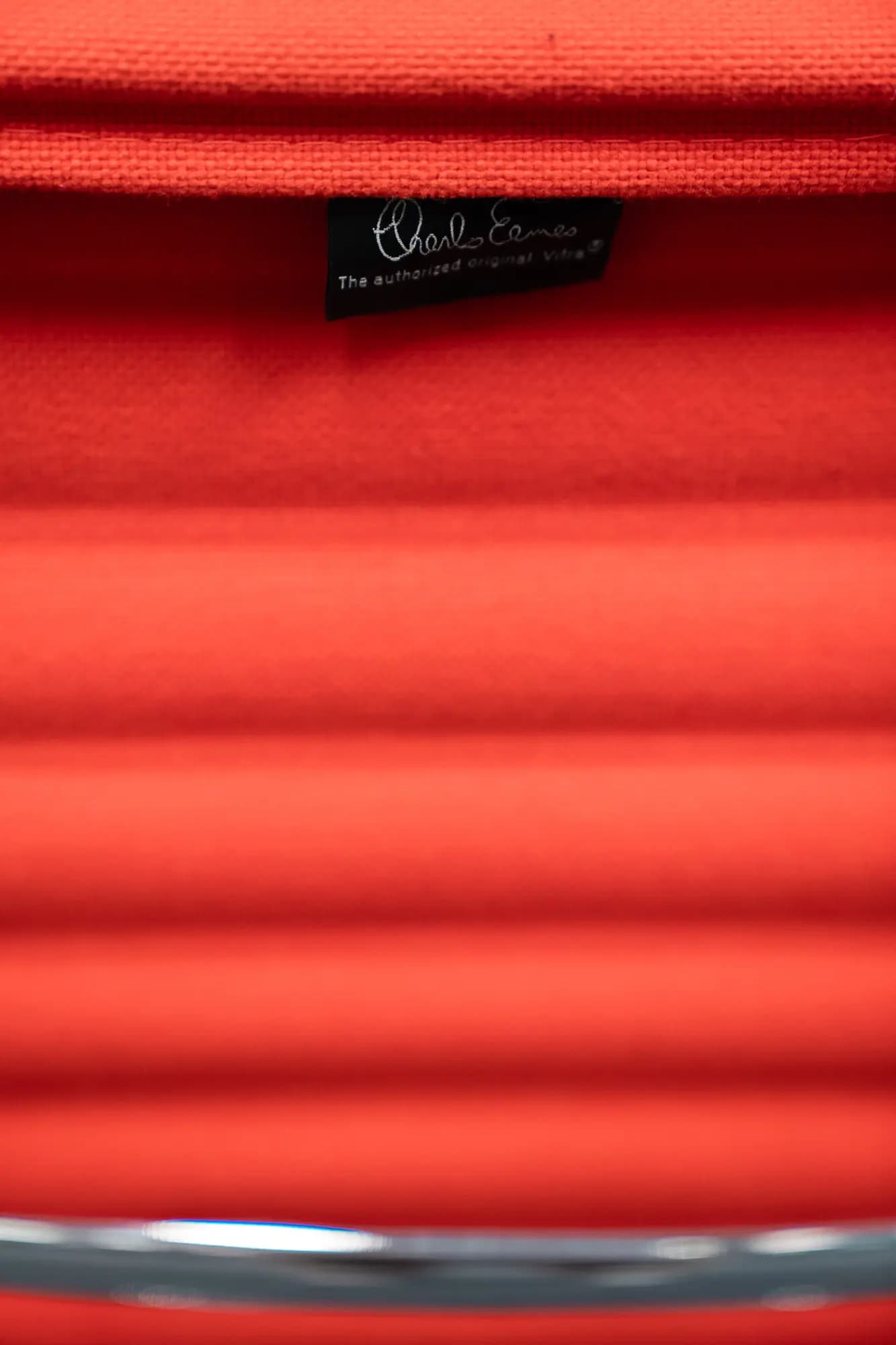 Vitra EA 119 orange chair on castors