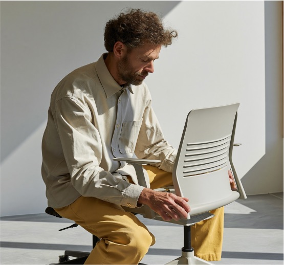 Relieve Furniture team member inspecting reused office furniture